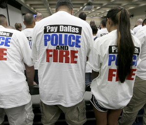 Dallas police and firefighters fill the gallery for a city council budget meeting at Dallas City Hall, Tuesday, Aug. 9, 2016, in Dallas. (AP Photo/LM Otero)
