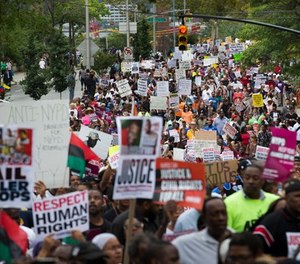 In this Aug. 23, 2014 file photo, demonstrators march to protest the death of Eric Garner in the Staten Island borough of New York.