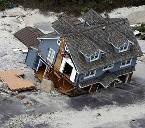 This aerial photo shows a collapsed house along the central Jersey Shore coast on Wednesday, Oct. 31, 2012.