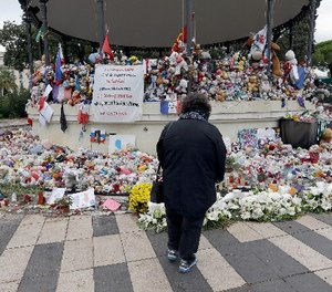 Flowers pile up at a makeshift memorial in a park on the Nice's famed Promenade des Anglais, on the eve of a national commemoration to the victims of the Nice attack in southern France,Thursday, Oct. 14, 2016.