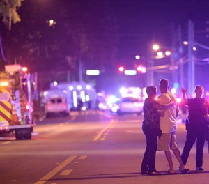 Orlando Police officers direct family members away from a shooting involving multiple fatalities at the Pulse Orlando nightclub in Orlando, Fla., Sunday, June 12, 2016.