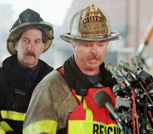 Worcester, Mass., District Fire Chief Michael McNamee talks with reporters on Dec. 6, 1999, about the search for the bodies of five of the six Worcester firefighters who died while battling a fire at an abandoned cold storage warehouse on Friday in Worcester.