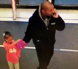 Pictured is a surveillance photo showing the child and her father.