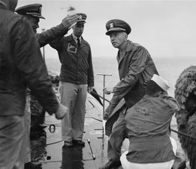 Rear Admiral Hyman G. Rickover, father of nuclear powered submarines, boards the USS Nautilus from the Navy Tug 534 in the Narrows below Brooklyn, New York on August 25, 1958. Cdr. William Anderson, head showing at left, awaits to greet the admiral aboard the U.S. Navy’s first nuclear sub. Anderson is skipper of the Nautilus. Saluting at left center is Lt. Donald P. Hall, gunnery officer of the Nautilus. The craft returned earlier from four-month voyage.
