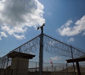 A fence stands at Elmore Correctional Facility in Elmore, Ala.