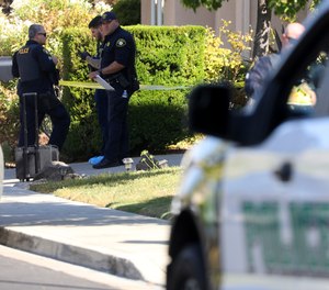 Police officers work the scene of a double homicide at a home on Wednesday, Sept. 7, 2022, in Dublin, Calif.