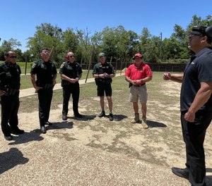 Alternative Ballistics' Alex Perez (right) speaks with deputies in Escambia County, Florida, whose department will evaluate The Alternative in anticipation of adoption. 