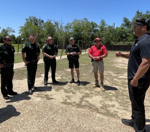 Alternative Ballistics' Alex Perez (right) speaks with deputies in Escambia County, Florida, whose department will evaluate The Alternative in anticipation of adoption.