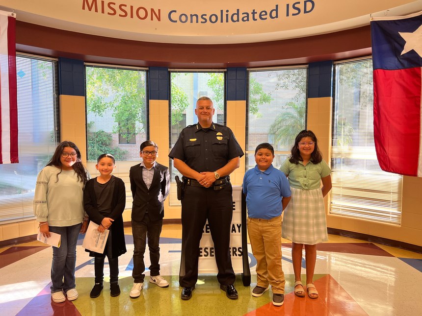 Chief Flores pictured with the next generation of Alton police officers.