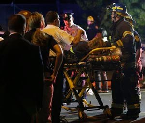 Emergency personnel transport a person at the scene of a train wreck, Tuesday, May 12, 2015, in Philadelphia.
