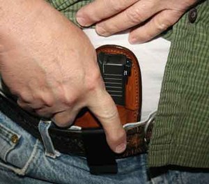 Appendix carry under a 5.11 Covert shirt and the requisite two-hand draw stroke. Weapon is a Glock 43 with night sights from Heinie Specialty Products, holster is a Bianchi model 100 Professional inside-the-pants leather holster.