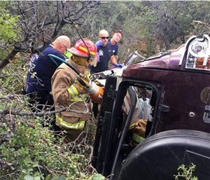 Authorities say a man trapped in his crashed vehicle on a central Arizona mountain for three days was rescued thanks to a couple taking sightseeing photos. (Kim Moore via AP)