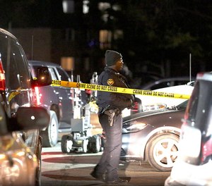 Authorities search an apartment complex Friday, Feb. 15, 2019, in Aurora, Ill., where the gunman who fatally shot several people at a manufacturing complex in the city is believed to have lived.