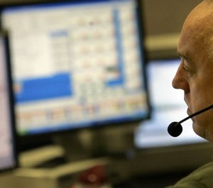 A 911 operator answered emergency calls at a Minneapolis dispatch center. (Photo/Tribune News Service)