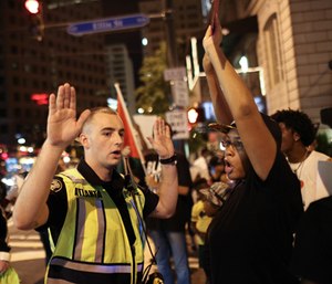 An Atlanta police officer tells Black Lives Matter protesters to move out of the street during a protest in downtown Atlanta, Saturday, Sept. 24, 2016.