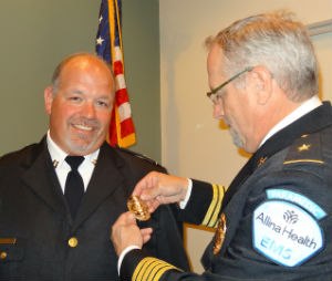 Badge pinning ceremony at Allina Health EMS in St. Paul, Minnesota. President Brian LaCroix pins Supervisor Scott Waibel upon completion of an on boarding process. (Image courtesy of Allina Health EMS)