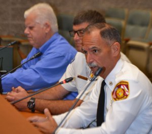 Fire Chief Marc Bashoor advocates for his fire department during a county commission meeting.