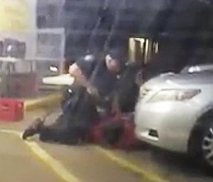 In this photo made from video, Alton Sterling is held by two Baton Rouge police officers, with one holding a hand gun, outside a convenience store in Baton Rouge, La. Moments later, one of the officers shot and killed Sterling. (Arthur Reed via AP)