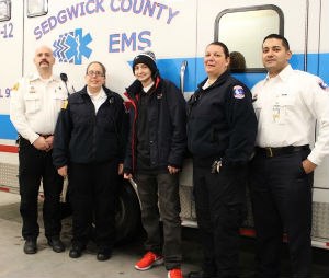 Kyle Begin (center) with Sedgwick County EMS personnel Maj. Kevin Hartley, Paramedic Cassie Powell, Capt. Pam Utter, and Col. Paul Misasi