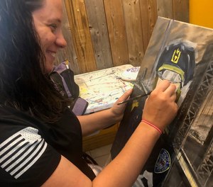 Paramedic Kate Bergen works on a portrait of Sue Keane, a retired Port Authority sergeant who responded to the attacks on Sept. 11, 2001.