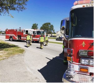 Company members from Engine 3 return to their apparatus after serving as the blocking unit for a motor vehicle accident.