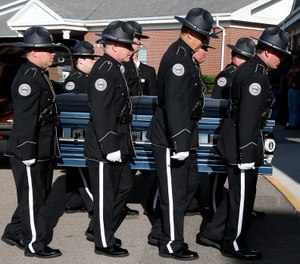 Members of the Biloxi Police Department Honor Guard escort the body of officer Robert McKeithen, into the First Baptist Church of Biloxi, Miss., Monday, May 13, 2019, for visitation. (AP Photo/Rogelio V. Solis)