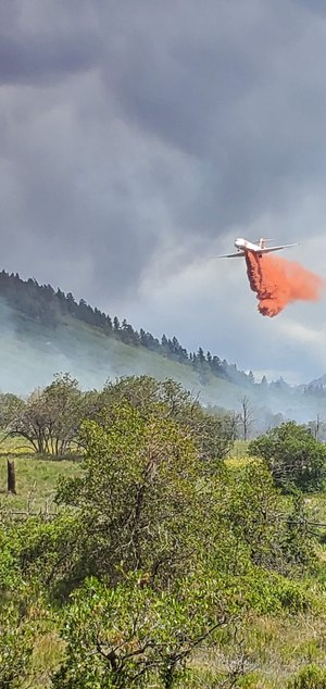 Everyone gets in the game on mutual aid. Here, an aerial super tanker deployed from Colorado Springs drops a load on the Green Meadows Fire in July 2020, when firefighters from Norwood, Telluride and other agencies joined forces in successful WUI home defense. Homes were saved with the help of a mutual mitigation program in collaboration with the West Region Wildfire Council.