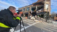Photos: Part of 2-story building collapses after car slams into storefront