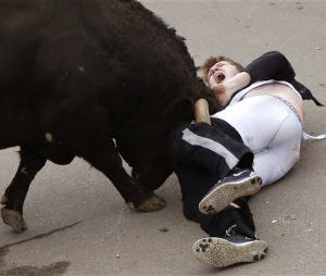 In this photo taken on Saturday, Feb. 14, 2015, Benjamin Miller, 20, from Georgia, in the US, is gored by a bull during the