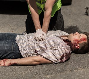An officer performing CPR.