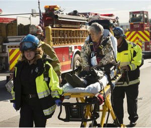 A woman is carried on a stretcher after a collision involving a commuter bus and two big rigs on eastbound State Route 60 at 7th Street in Hacienda Heights, Calif. on Wednesday, Jan. 7, 2015. (AP Photo/San Gabriel Valley Tribune, Keith Durflinger)