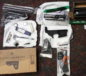 This undated photo provided by the Office of Attorney General of New Jersey shows parts of guns confiscated after being sold by mail order from a California company.