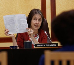 State Sen. Nancy Skinner, D-Berkeley, chairwoman of the Senate public safety committee, displays a copy of Democratic state Sen. Anna Caballero's police-backed law enforcement training bill during a hearing at the Capitol Tuesday, April 23, 2019, in Sacramento, Calif.