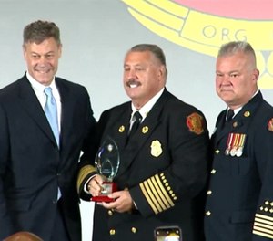 In this 2022 photo, Chief Gary Ludwig accepts the 2022 Career Fire Chief of the Year award, flanked by Jim Johnson (left), Pierce Manufacturing president; and IAFC President Ken Stuebing (right).