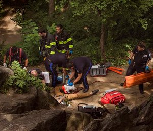 A man, center bottom, bleeds from his injured leg as he gets helped from paramedics in Central Park in New York. (AP Photo/Andres Kudacki)