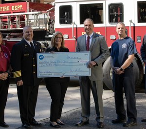 ADT’s Jay Robertson, who is also a volunteer firefighter, presents a $100,000 contribution to Heather Schafer, CEO of the National Volunteer Fire Council, as part of ADT’s commitment to help bring awareness to recruiting and retaining more volunteer firefighters in communities across America