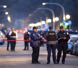 Chicago police work the scene of a shooting in the 6300 block of South Seeley on Saturday, April 6, 2019. Authorities say two children were among the several people who were wounded when two men opened fire Saturday evening on a baby shower outside of a home on the South Side of Chicago. (Chris Sweda/Chicago Tribune via AP)