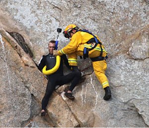 Morro Bay Fire Department Capt. Todd Gailey was lowered from a helicopter by cable to pluck Michael Banks and take him to safety. (Bob Isenberg via AP)