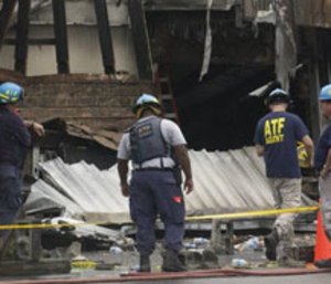 Federal investigators look over the scene after the Charleston fire.