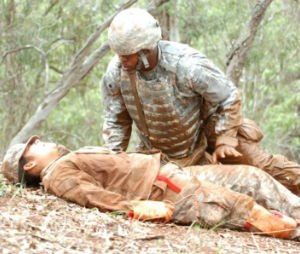 Spc. Dameon Williams, human resource specialist, 2nd Battalion, 25th Aviation Regiment, 25th Combat Aviation Brigade, evaluates a casualty by initially checking her consciousness during the 25th CAB's CLS training and qualification field training exercise at Wheeler Army Air Field, Nov. 18.