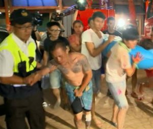 In this screen grab taken from ETTV, injured concert spectators are treated after an accidental explosion during a music concert at the Formosa Water Park in New Taipei City, Taiwan, Saturday, June 27, 2015. The New Taipei City fire department says 200 people were injured in an accidental explosion of colored theatrical powder Saturday night near a performance stage where about 1,000 people were gathered for party. (ETTV via AP)