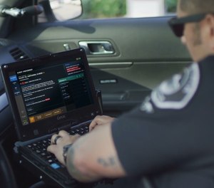A patrol officer accesses CAD information in their patrol car.