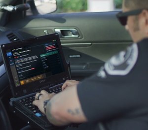 A patrol officer accesses CAD information in their patrol car.