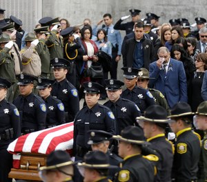 Family members follow the flag draped coffin of Davis Police Officer Natalie Corona before funeral services for Corona at the University of California, Davis, Friday, Jan. 18, 2019, in Davis, Calif. Corona was was shot and killed Jan. 10, responding to scene of a three-car crash in Davis. Police say gunman Kevin Douglas Limbaugh, 48, not involved in the crash, rode up on a bicycle and without warning, opened fire on Corona. (AP Photo/Rich Pedroncelli)