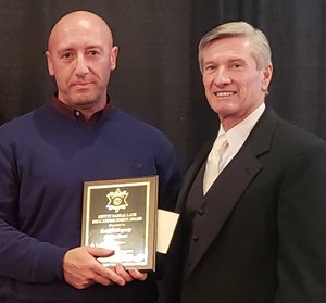 Corporal Peter Hart receives an award from Sheriff Leon Lott during the Christmas awards banquet, Dec. 15, 2018.