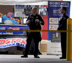 Officers exit the Corona Costco following a fatal shooting involving an off-duty LAPD officer inside the wholesale warehouse store on June 14, 2019.