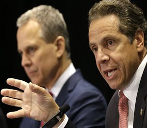 New York Governor Andrew Cuomo, right, speaks while New York Attorney General Eric Schneiderman listens during a news conference in New York, Wednesday, July 8, 2015.