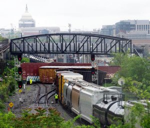 Emergency personnel work at the scene after a CSX freight train derailed, spilling hazardous material, in Washington Sunday. (AP Photo/Cliff Owen)