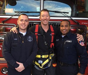 Firefighter Sean O’Rourke reunites with EMTs Adam Harrow and Corey Christian, who administered medical care when O’Rourke was seriously injured last year. (Photo/FDNY)