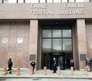 Law enforcement officers secure the scene after a man fired shots outside the Earle Cabell Federal Building in downtown Dalla, Monday, June 17, 2019. (Tom Fox/The Dallas Morning News)